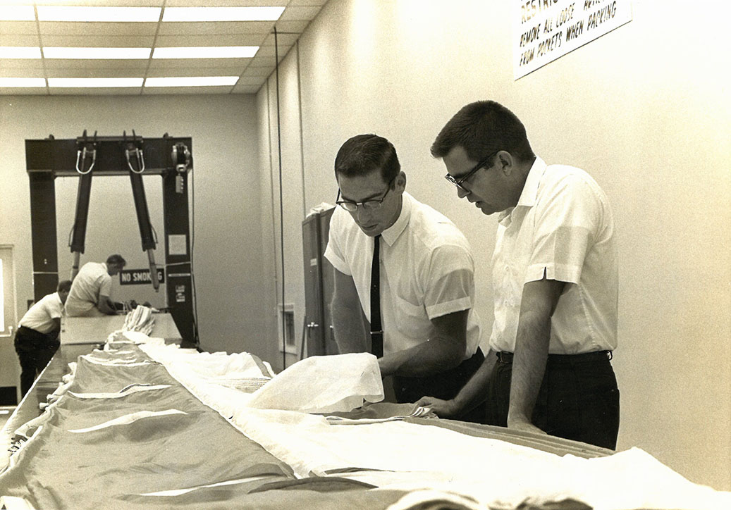 Scientists inspecting parachute material for Gemini mission