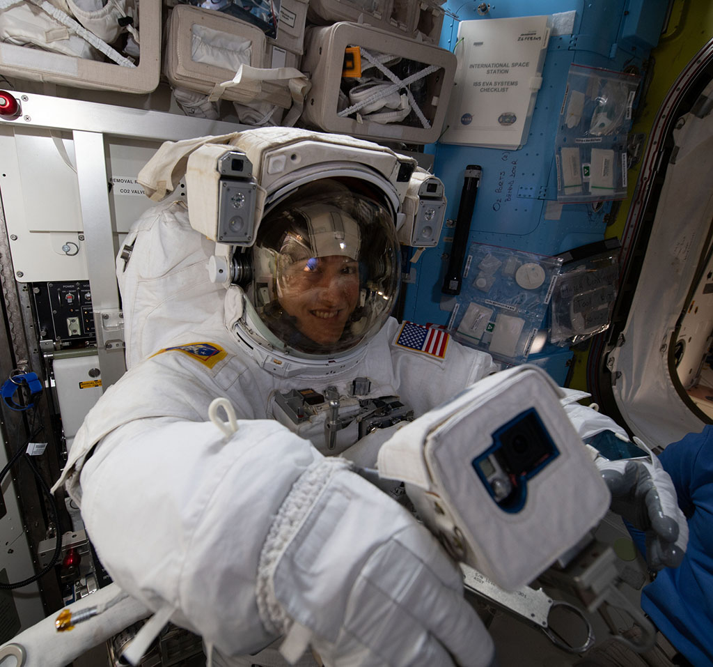 Christina Koch wearing an astronaut suit in the space station