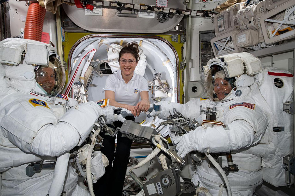 Christina Koch and two other astronauts in space